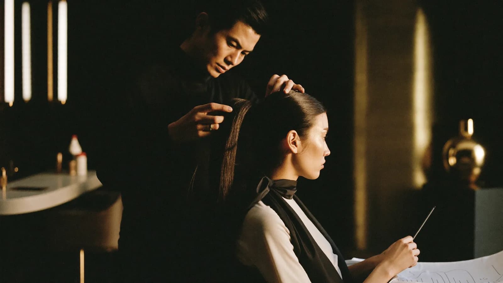 Hair stylist working with a client in a bright salon